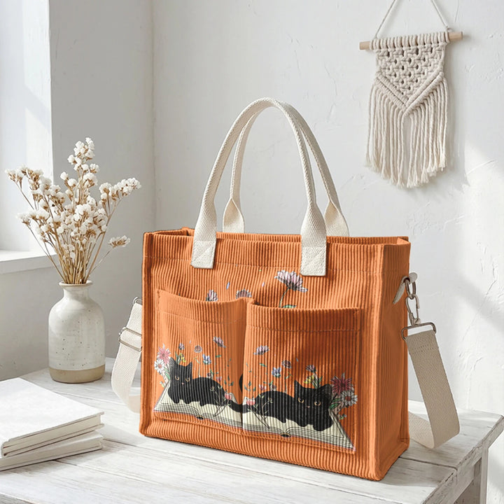 Sac à dos en velours côtelé rose avec impression de chat noir mignon et de livres, grande capacité et plusieurs poches pour les amoureux des chats, adapté pour les trajets domicile-travail.