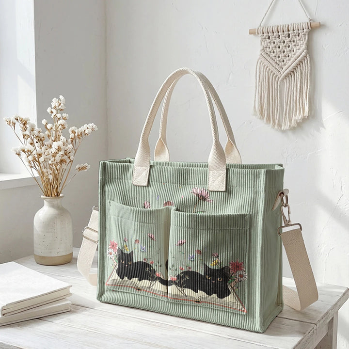 Sac à dos en velours côtelé rose avec impression de chat noir mignon et de livres, grande capacité et plusieurs poches pour les amoureux des chats, adapté pour les trajets domicile-travail.