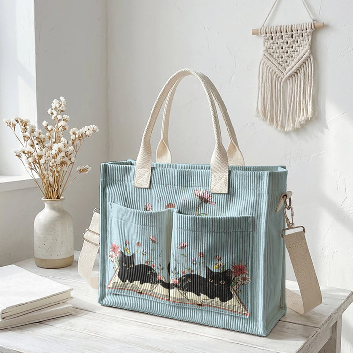 Sac à dos en velours côtelé rose avec impression de chat noir mignon et de livres, grande capacité et plusieurs poches pour les amoureux des chats, adapté pour les trajets domicile-travail.